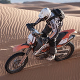 Desert adventure rider wearing Kriega R15 motorcycle backpack