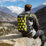 Adventure rider wearing lime colored Kriega Trail18 motorcycle backpack