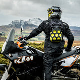 KTM rider wearing Kriega Trail9 motorcycle backpack in wilderness