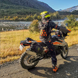 KTM off-road rider wearing orange colored Kriega Trail9 motorcycle backpack