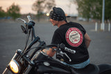 Rider with motorcycle wearing short sleeve motorcycle t-shirt with retro sign design showing back